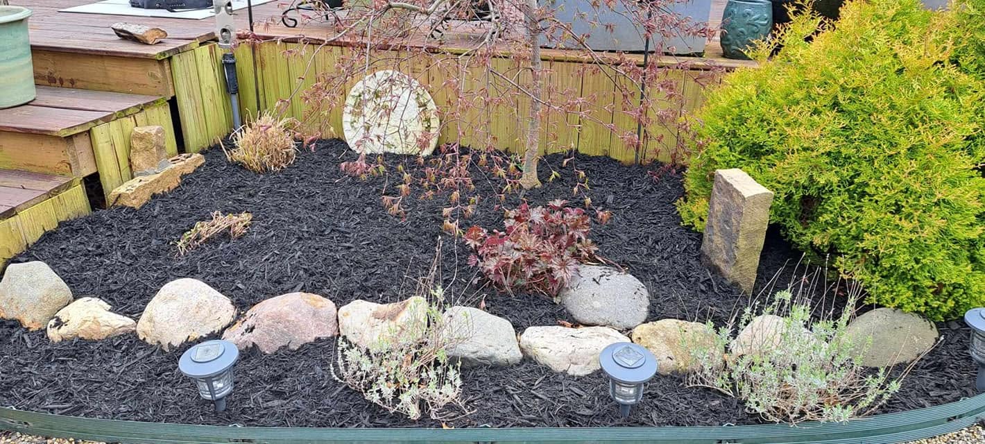 Custom stone walkway and garden beds